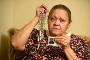 Lucia Santiago holds the cremation jewelry that held the ashes of her late husband Miguel.