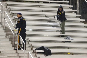 Pleasantville police search the stands after a shooting that occurred during a football game at Pleasantville High School in Pleasantville, N.J.