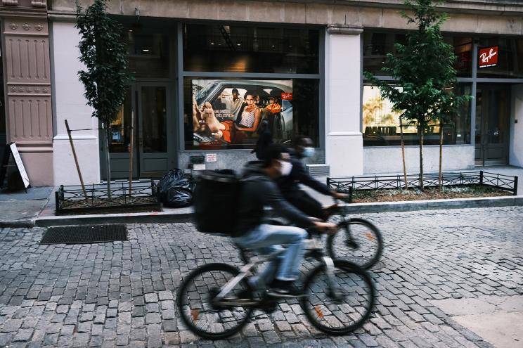 People on bikes ride through Manhattan’s SoHo neighborhood