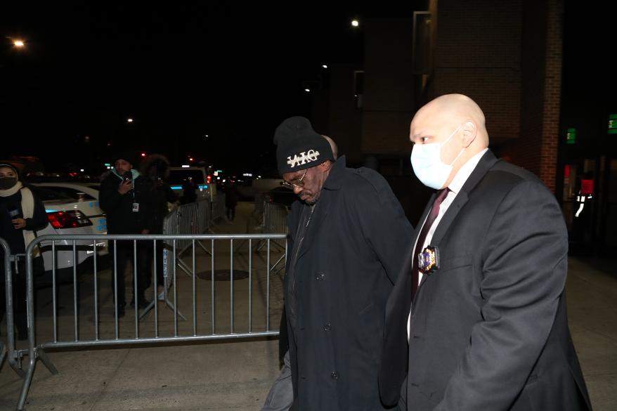 Serial killer Kevin Gavin (left) walks out of the 73rd precinct in Brooklyn.