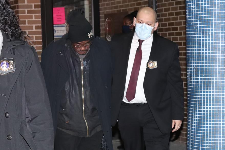 Serial killer Kevin Gavin (left) walks out of the 73rd precinct in Brooklyn.