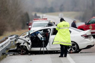 Emergency crews work the scene of a fatal crash involving a charter bus and car on the AA highway in Campbell County, Ky.