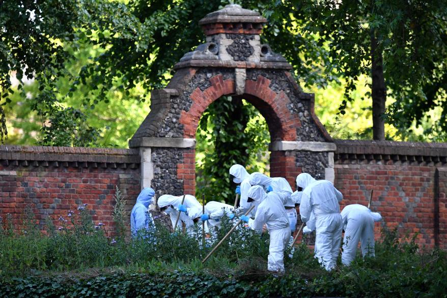 On June 22, 2020, police forensics officers conduct a search outside an entrance to Forbury Gardens park in Reading, west of London, where the stabbing occured