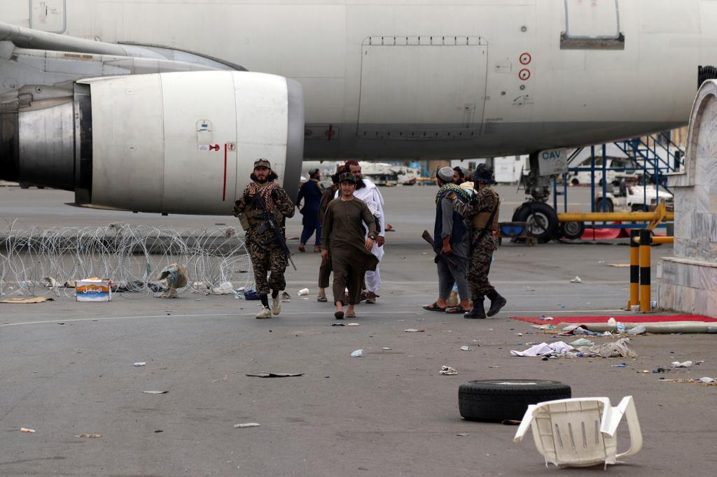 Taliban special force fighters secure the inside of Hamid Karzai International Airport after the U.S. military's withdrawal.