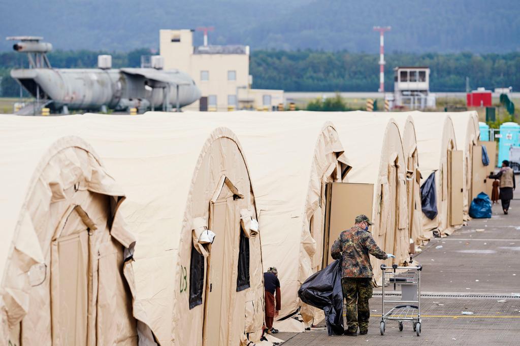 A US soldier walks through shelters in Ramstein which doubles as a haven for those who were evacuated from Afghanistan.