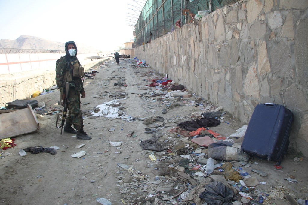 A Taliban member is seen at the explosion site where 13 US service members were killed near the Kabul Airport in Afghanistan on August 27, 2021.
