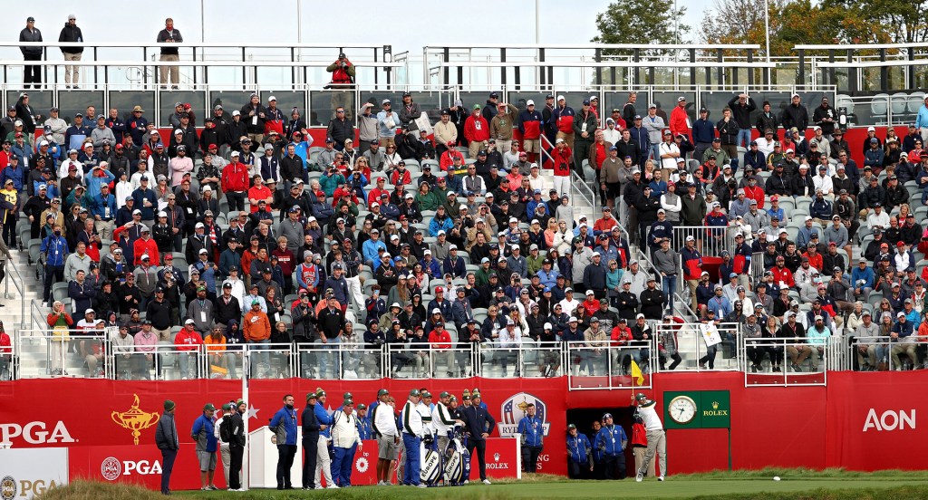 A full crowd watches Sergio Garcia tees off on the first tee during a Ryder Cup practice round.