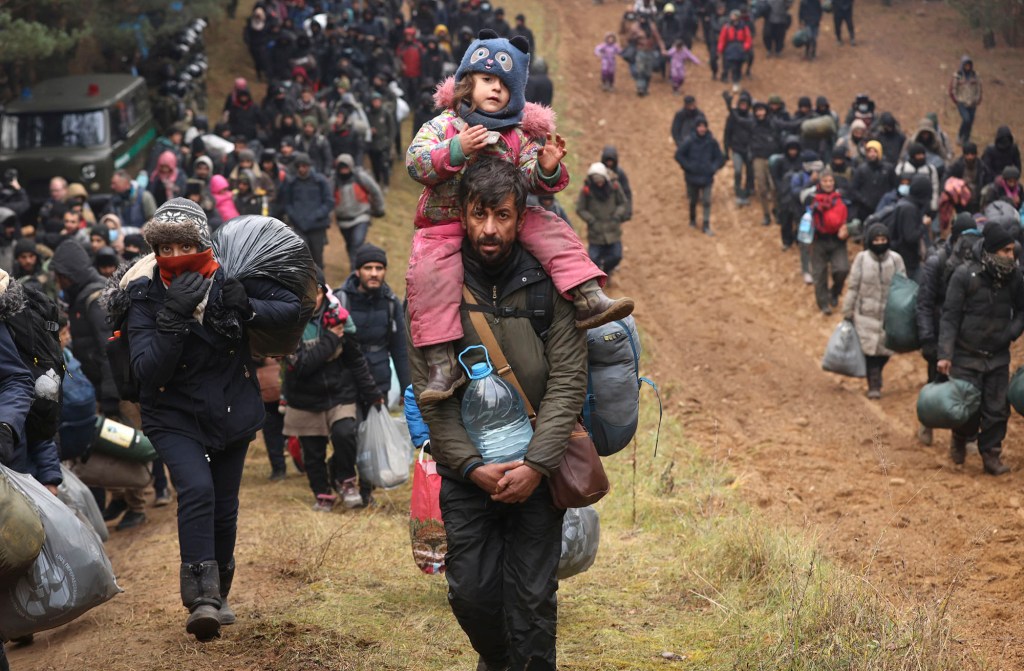 Migrants make their way to the checkpoint "Kuznitsa" at the Belarus-Poland border.