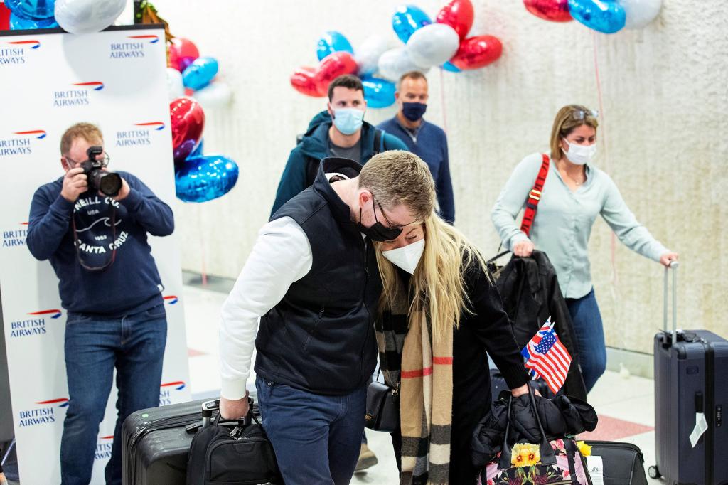 Reunited family members walk out of the terminal after landing in the British Airways flight at JFK International Airport in New York, U.S., November 8, 2021.