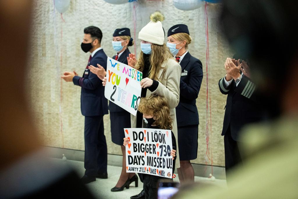 People wait for their relatives after the arrival of the British Airways flight at JFK