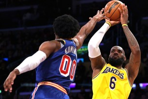 LeBron James, who scored 56 points, shoots over Jonathan Kuminga during the Lakers' 124-116 win over the Warriors.