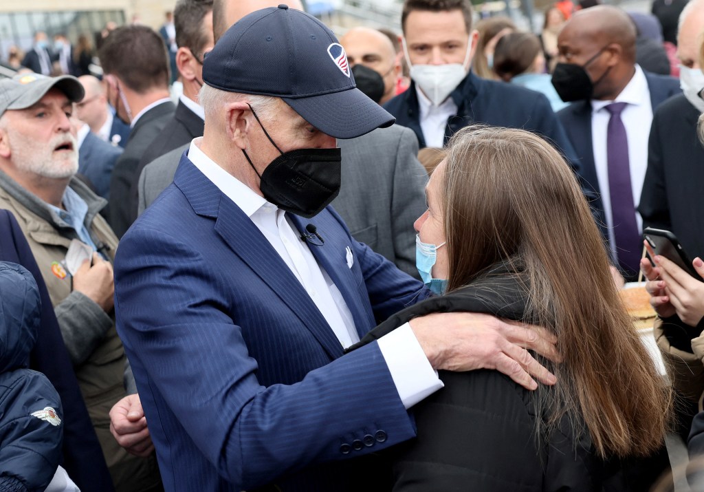 President Biden speaks with a woman as he visits Ukrainian refugees at the PGE National Stadium, in Warsaw, Poland on March 26, 2022. 