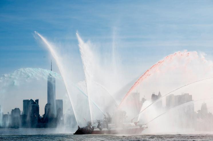 "Firefighter II" from the Fire Department of New York sprays water to salute the Fleet Week parade, on May 22, 2019 in New York. (Photo by Johannes EISELE / AFP) (Photo by JOHANNES EISELE/AFP via Getty Images)