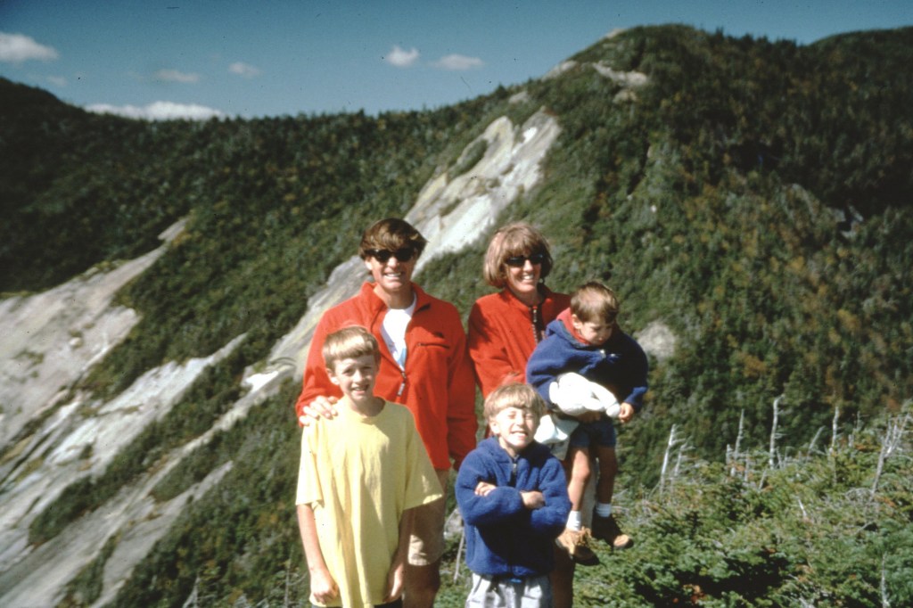 Lowe (left) with brothers Sam (center) and Isaac (right), and parents Alex and Jenni in the early '90s. 