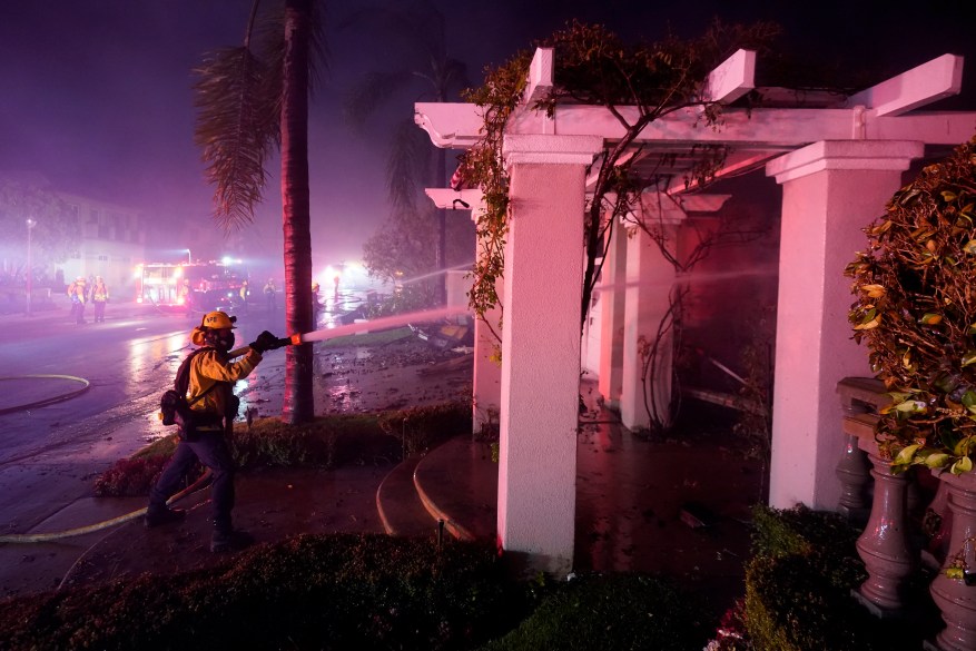 Firefighters make progress putting out a fire at a palatial estate in Laguna Niguel.