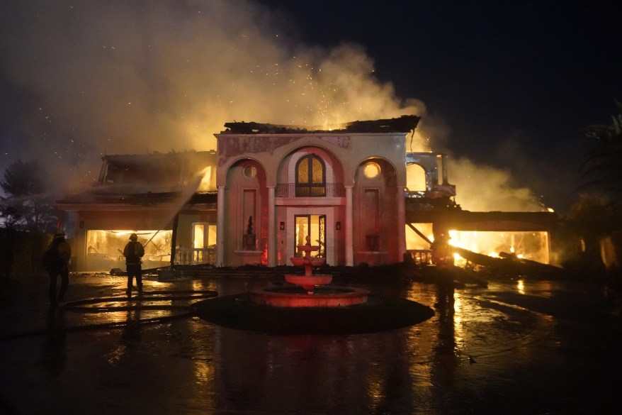 Smoke rises from a burning mansion in Laguna Niguel.