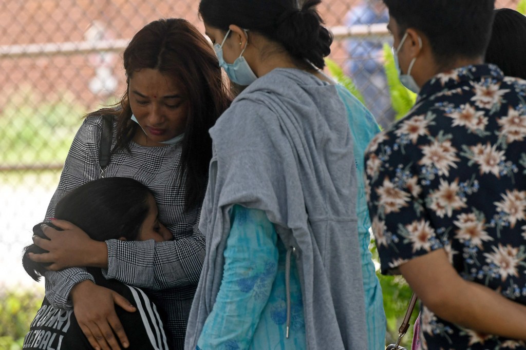 Family members of the Tara Air passengers grieving at the airport in Pokhara on May 30, 2022. 