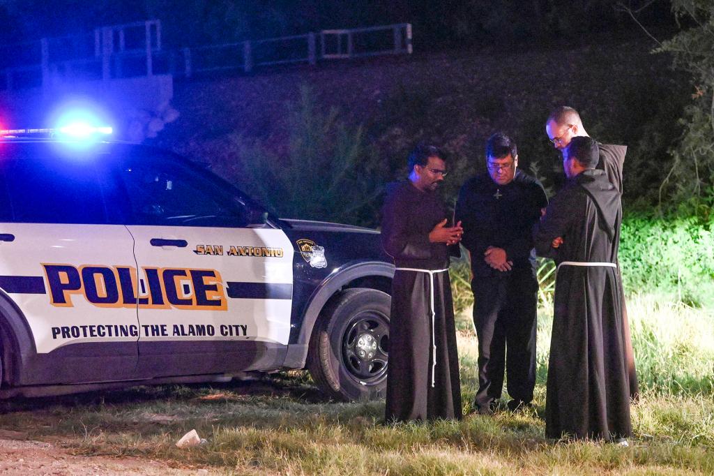 Local Catholic priests praying at the scene of the tragedy in San Antonio.