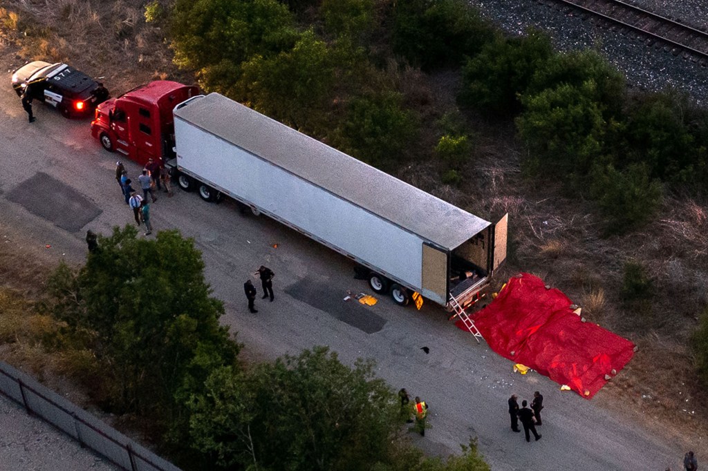 Police at the scene of where at least 50 migrants were found dead in the back of a truck near San Antonio, Texas on June 27, 2022.