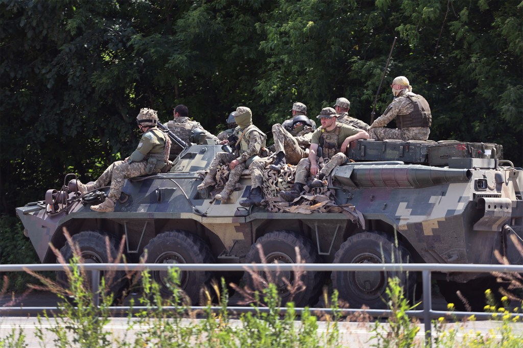 Ukrainian soldiers traveling on a military vehicle near Druzhkivka, Ukraine on June 19, 2022. 