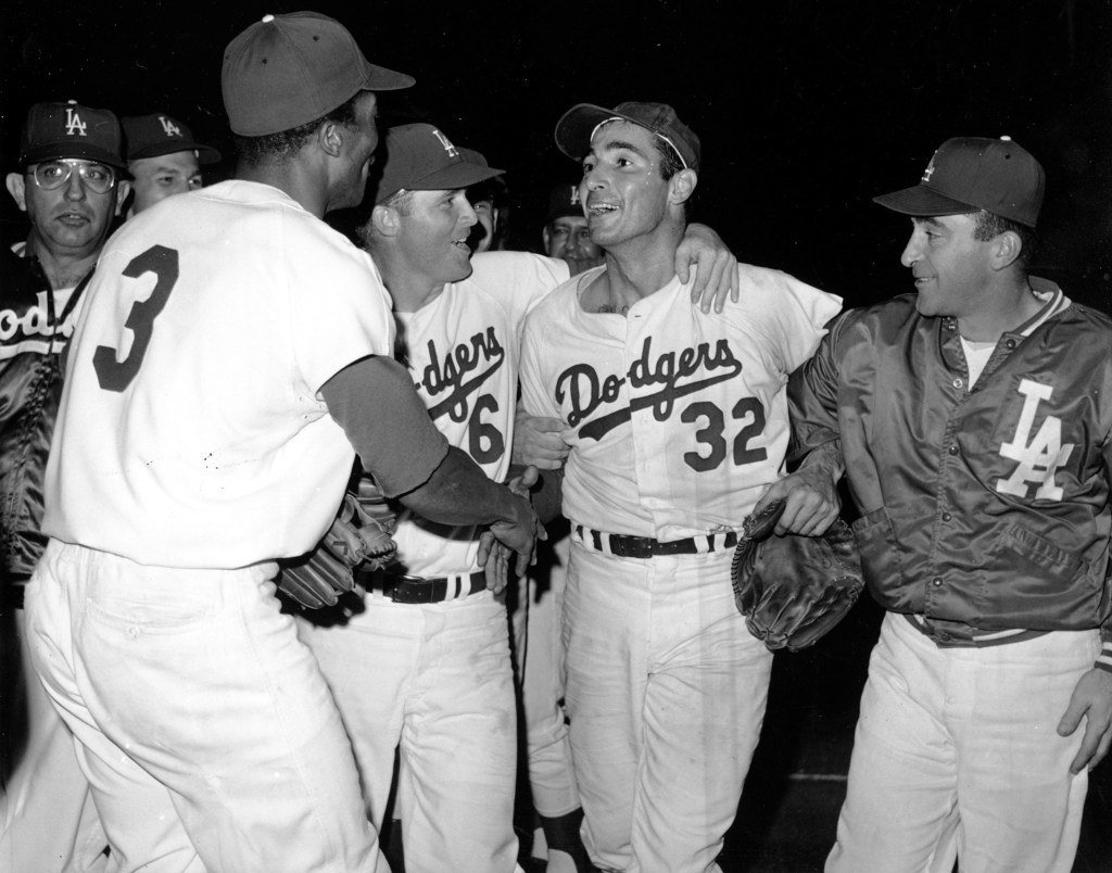 Sandy Koufax is rushed by teammates after throwing a perfect game against the Chicago Cubs on September 9, 1965.