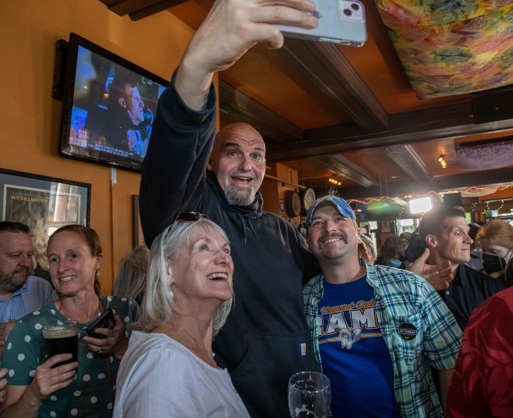 One day before his stroke, on May 12, 2022, John Fetterman took a selfie with voters while campaigning for US Senate at the Holy Hound Tap Room in York, Pa.