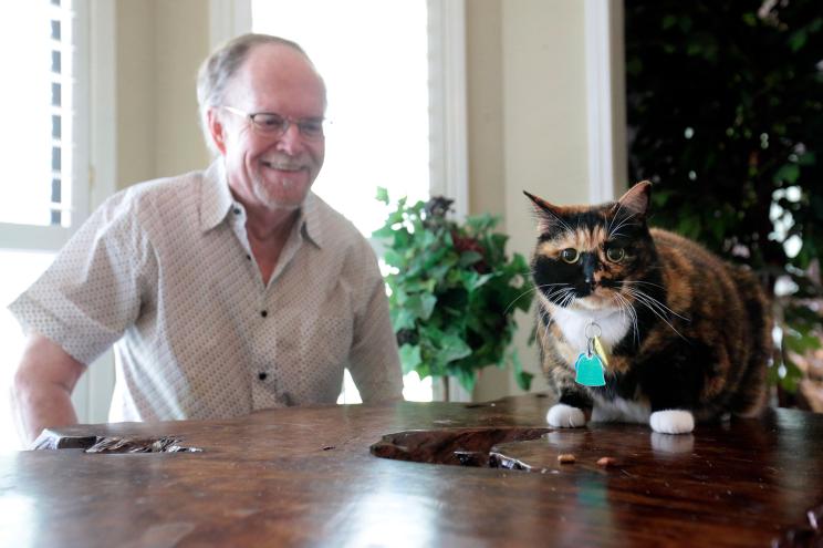 Fred Everitt of Tupelo, Miss., is all smiles after his cat, "Bandit", alerted him in the middle of the night that two men were trying to break into the back door of his home, July 29, 2022, in Tupelo, Miss.