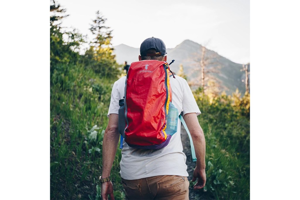 person hiking with Cotopaxi backpack. 