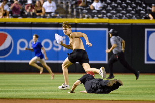 One of the runners ripped off his white t-shirt, which drew roars from the crowd.