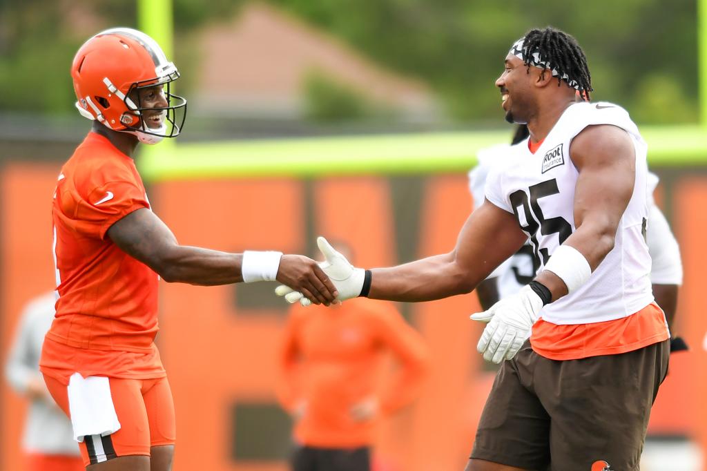 Deshaun Watson shakes hands with defensive end Myles Garrett