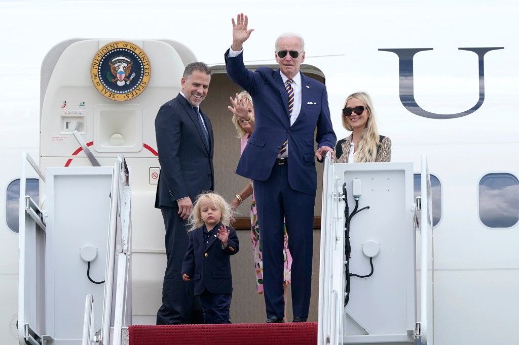 President Biden waving with his family members on Air Force One at Andrews Air Force Base in Maryland as they prepare to South Carolina for a vacation on August 10, 2022.