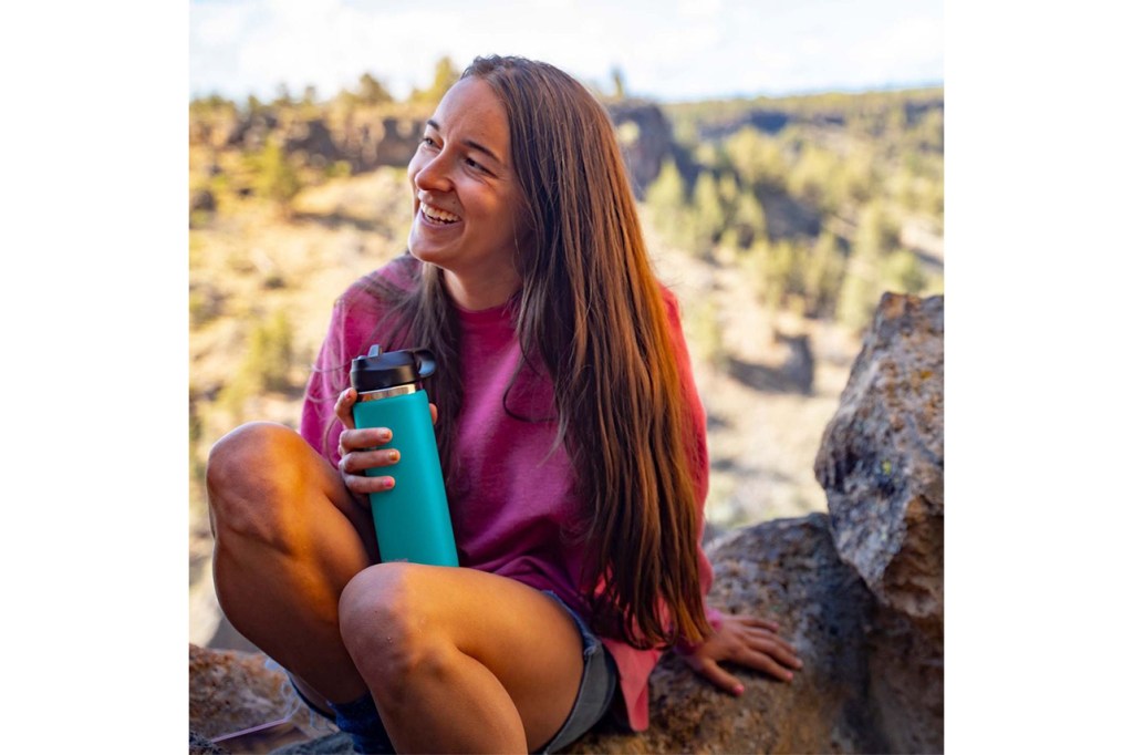 Women holding hydroflask water bottle. 