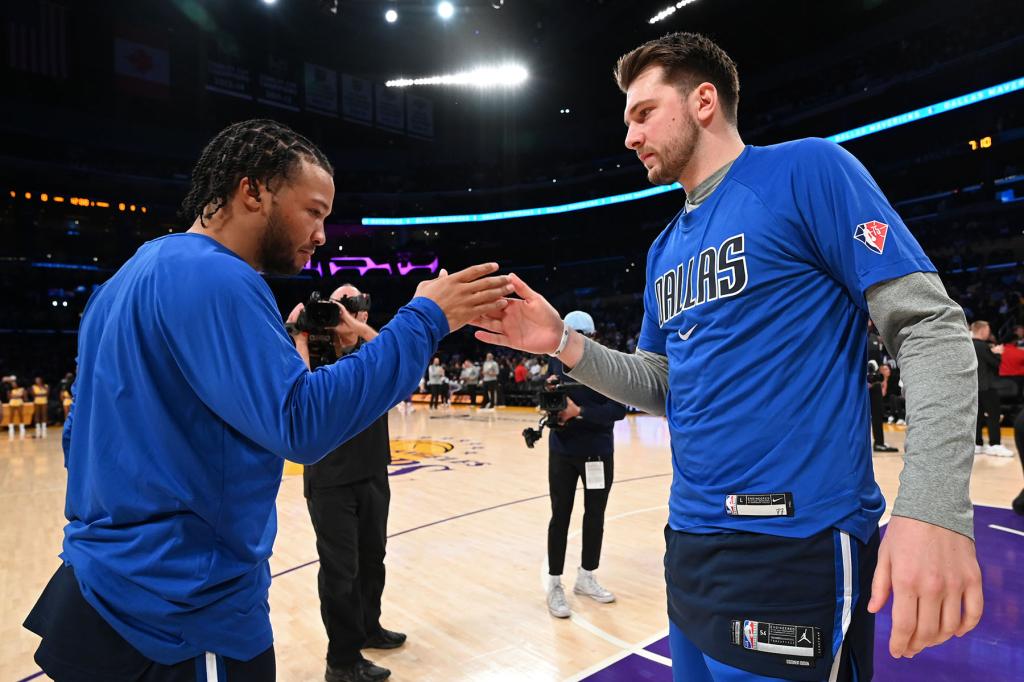 Jalen Brunson #13 of the Dallas Mavericks high fives Luka Doncic #77 of the Dallas Mavericks before the game against the Los Angeles Lakers on March 1, 2022 at Crypto.Com Arena in Los Angeles, California.