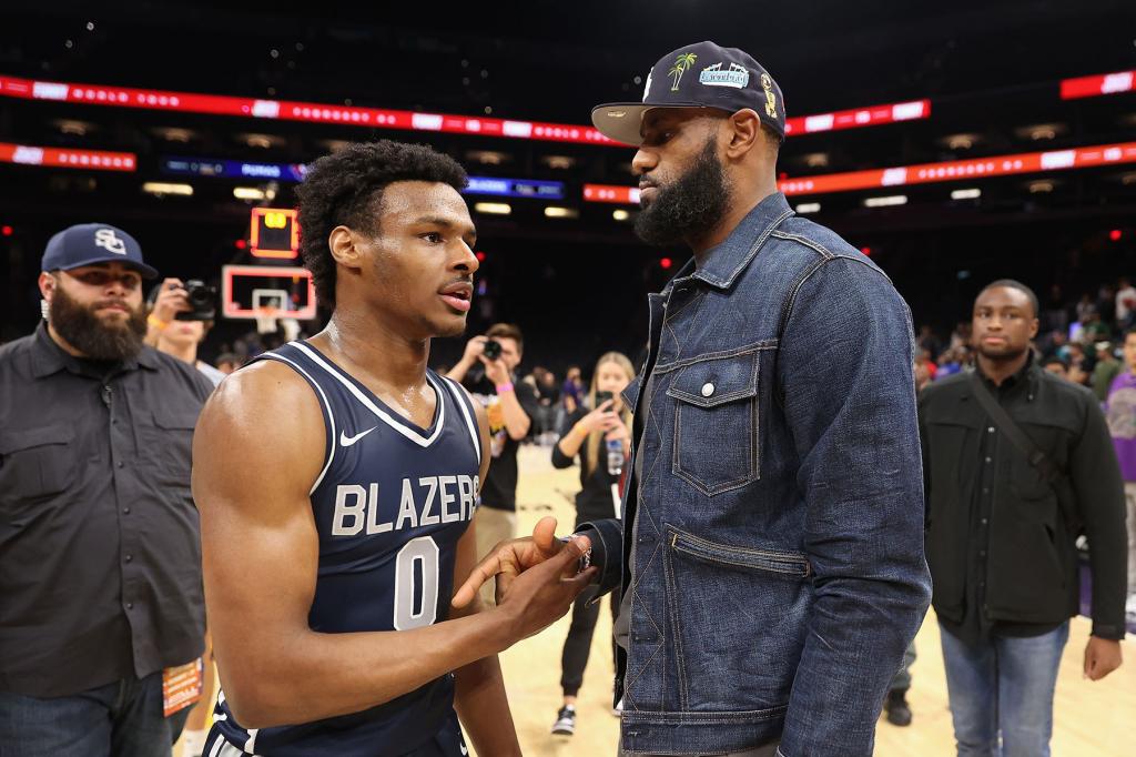 Bronny James#0 of the Sierra Canyon Trailblazers is greeted by his father and NBA player LeBron James after defeating the the Perry Pumas in the Hoophall West tournament at Footprint Center on December 11, 2021 in Phoenix, Arizona. 