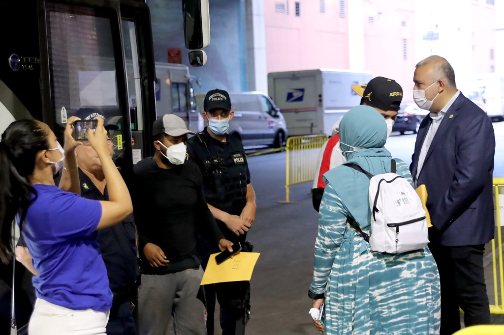 Photo of: New York City at the 42nd Street bus terminal in Manhattan refugees arrives  in New York City.in Manhattan.
