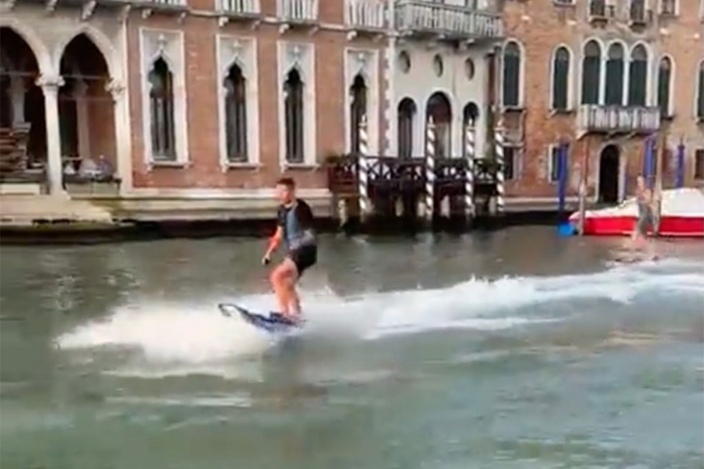 The social media clip shows the two speed surfing down Venice's Grand Canal on August 17, 2022.The social media clip shows the two speed surfing down Venice's Grand Canal on August 17, 2022.