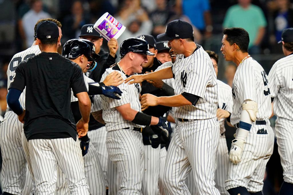 New York Yankees' Josh Donaldson, center, celebrates with teammates after hitting a walk-off grand slam during the tenth inning of a baseball game against the Tampa Bay Rays Wednesday, Aug. 17, 2022, in New York. The Yankees won 8-7. 