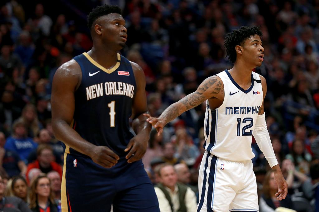 Zion Williamson #1 of the New Orleans Pelicans and Ja Morant #12 of the Memphis Grizzlies stand on the court during a NBA game at Smoothie King Center on January 31, 2020 in New Orleans, Louisiana.