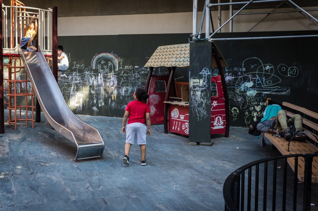 A picture of a kids playing in a playground.