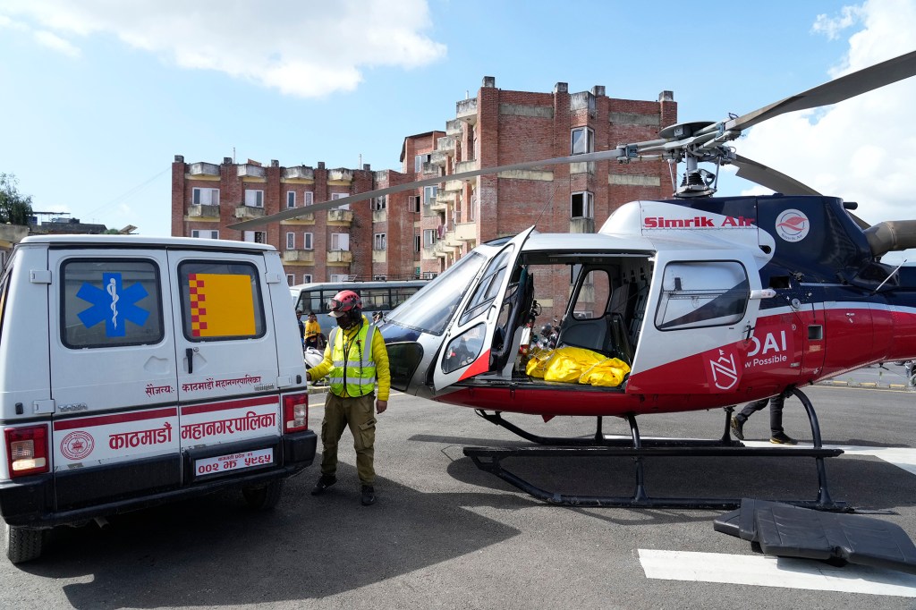 A helicopter carrying the body of famed U.S. extreme skier, Hilaree Nelson, lands at a hospital in Kathmandu