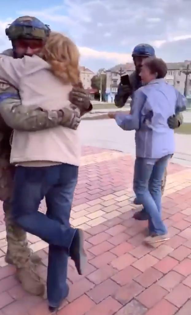 Women embrace Ukrainian soldiers in Balakliia, a city in Kharkiv.