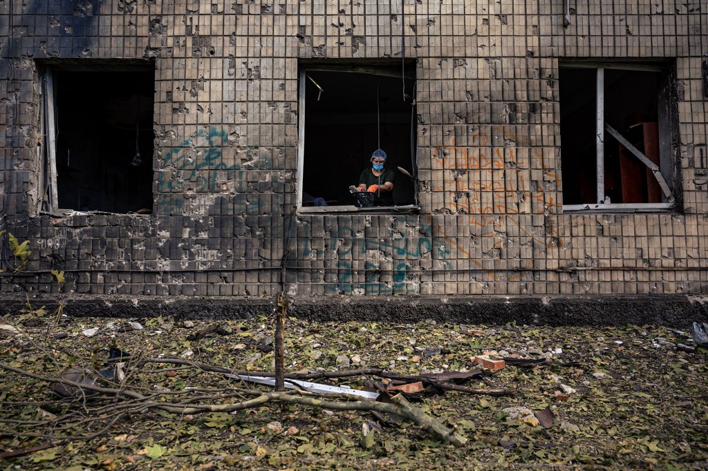 A medical staff cleans the debris in Primary Care center and Family clinic following a missile strike in Mykolaiv on September 4, 2022.