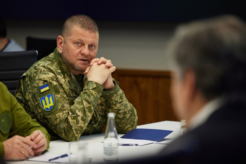 Zaluzhnyi is a white man with a shaved head and green camouflage fatigues.