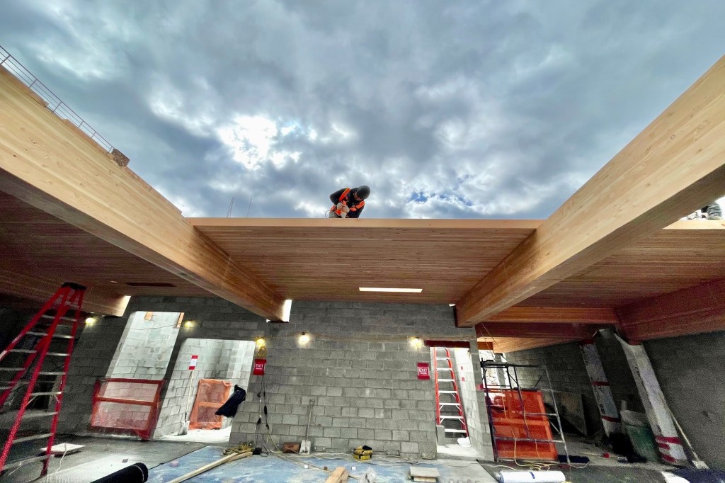 A man working on the Timber House.