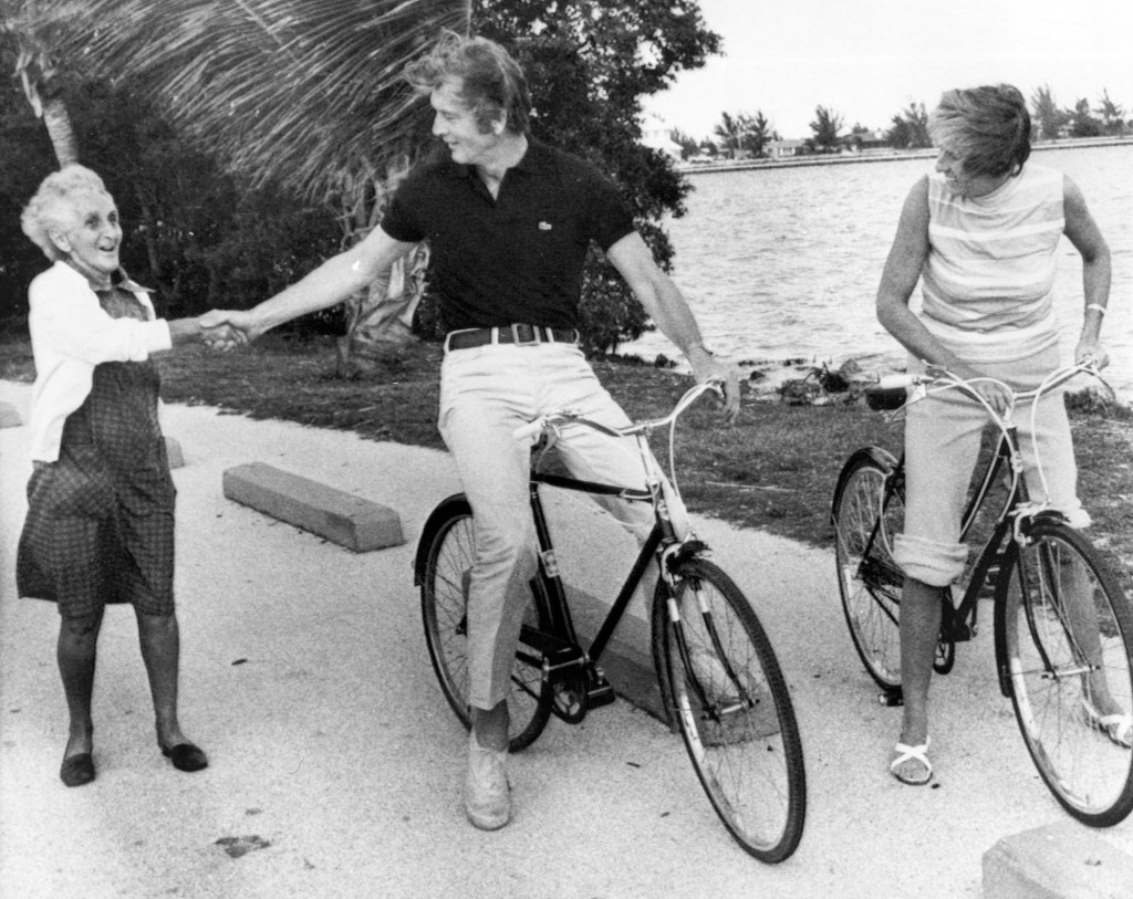 Cycling For Votes -- New York Mayor John Lindsay stops on his Sunday morning bicycle tour of Miami's coconut Grove to shake hands with a potential voter. Lindsay and his wife, Mary, right, rode bikes throughout the section as he continued his campaign for Florida's presidential primary tomorrow. April 12, 1975. (Photo by New York Post Archives /(c) NYP Holdings, Inc. via Getty Images)