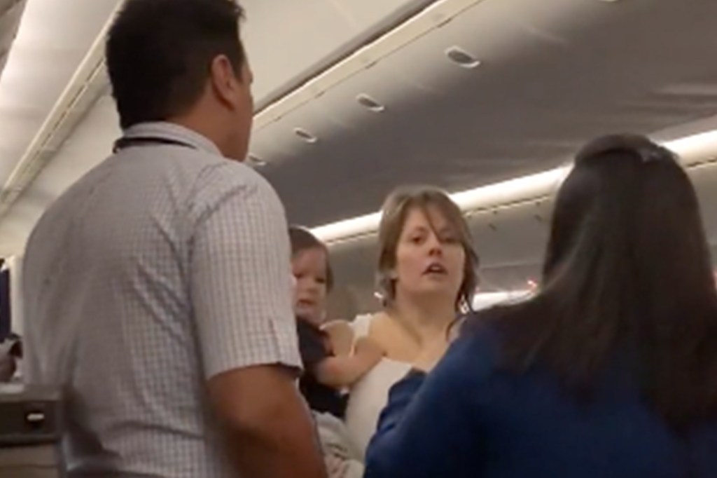 Woman holding child on plane