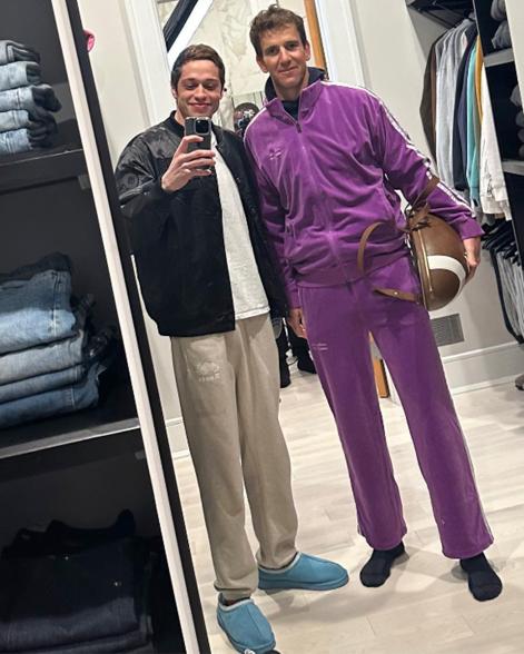 Eli Manning models a purple track suit in a photo with Pete Davidson.