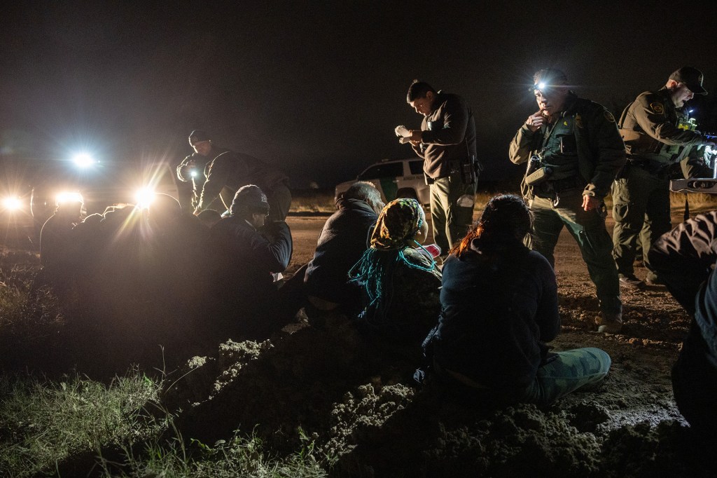 Border Patrol agents detain a group of immigrants from Mexico and Central America near the U.S.-Mexico border on Dec. 1, 2022 in McAllen, Texas.