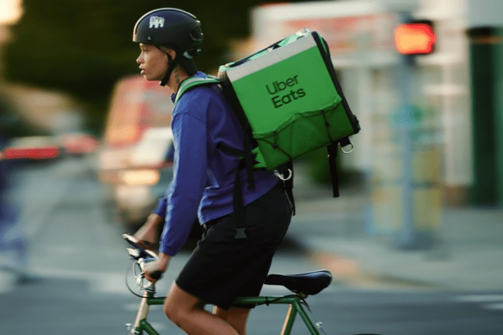 A person on a bike delivering Uber Eats