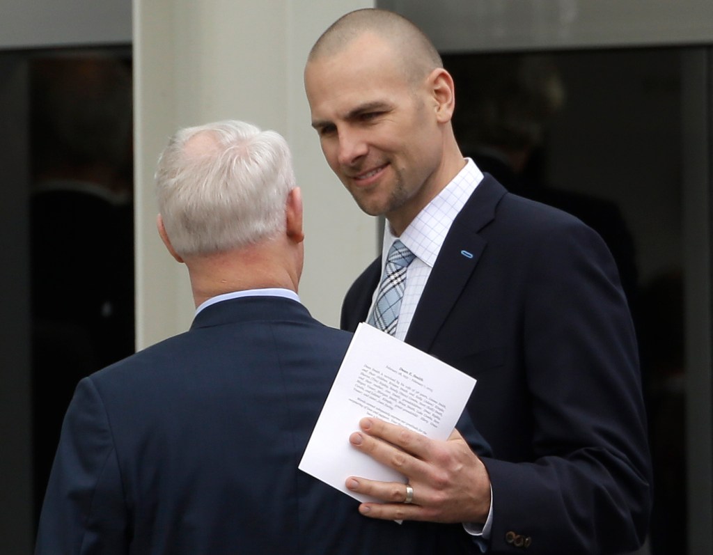 Former North Carolina basketball player Eric Montross, right, speaks with another attendee following a private church service for former North Carolina basketball coach Dean Smith in Chapel Hill, N.C., Thursday, Feb. 12, 2015.